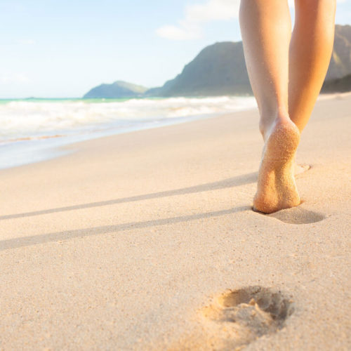 feet-walking-sandy-beach
