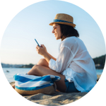 woman on phone at the beach image